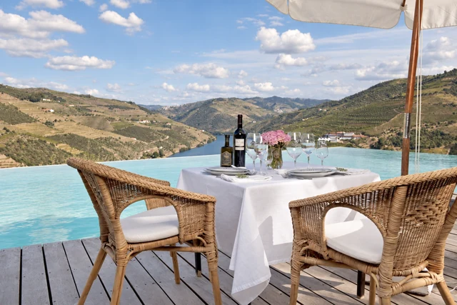 A table set for lunch on a terrace overlooking Douro vineyards