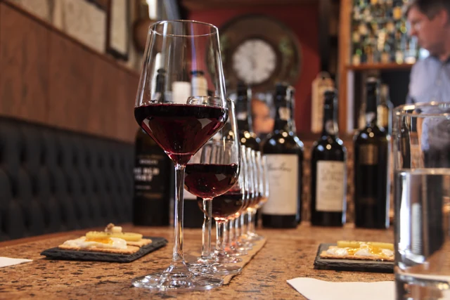 Glasses of red wine prepared for a tasting in a wine cellar